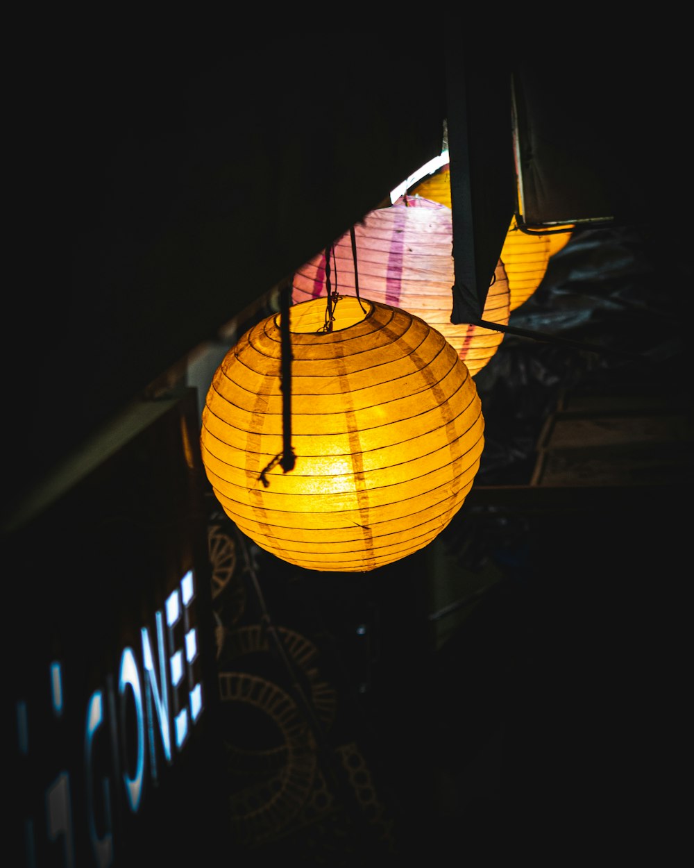 yellow paper lantern on black metal frame