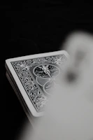 Close-up of The Hanged Man card details showing intricate line work and subtle color gradients.