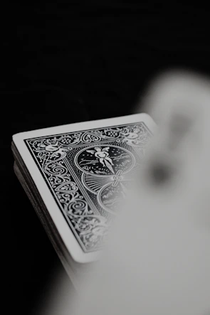 Close-up of The Hanged Man card details showing intricate line work and subtle color gradients.