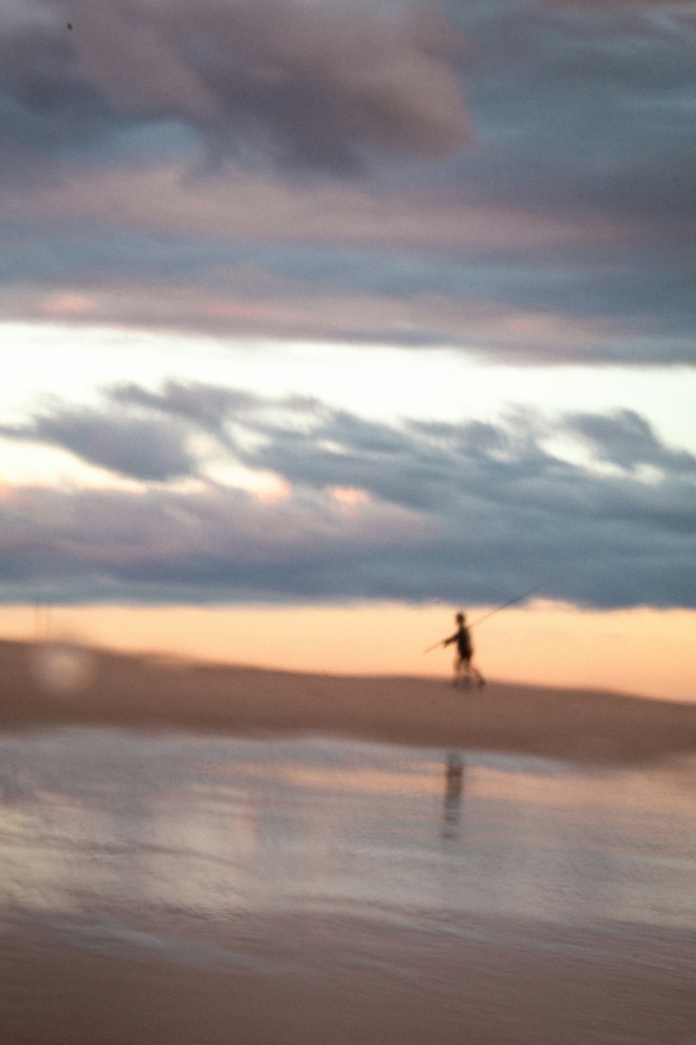 person standing on seashore during daytime