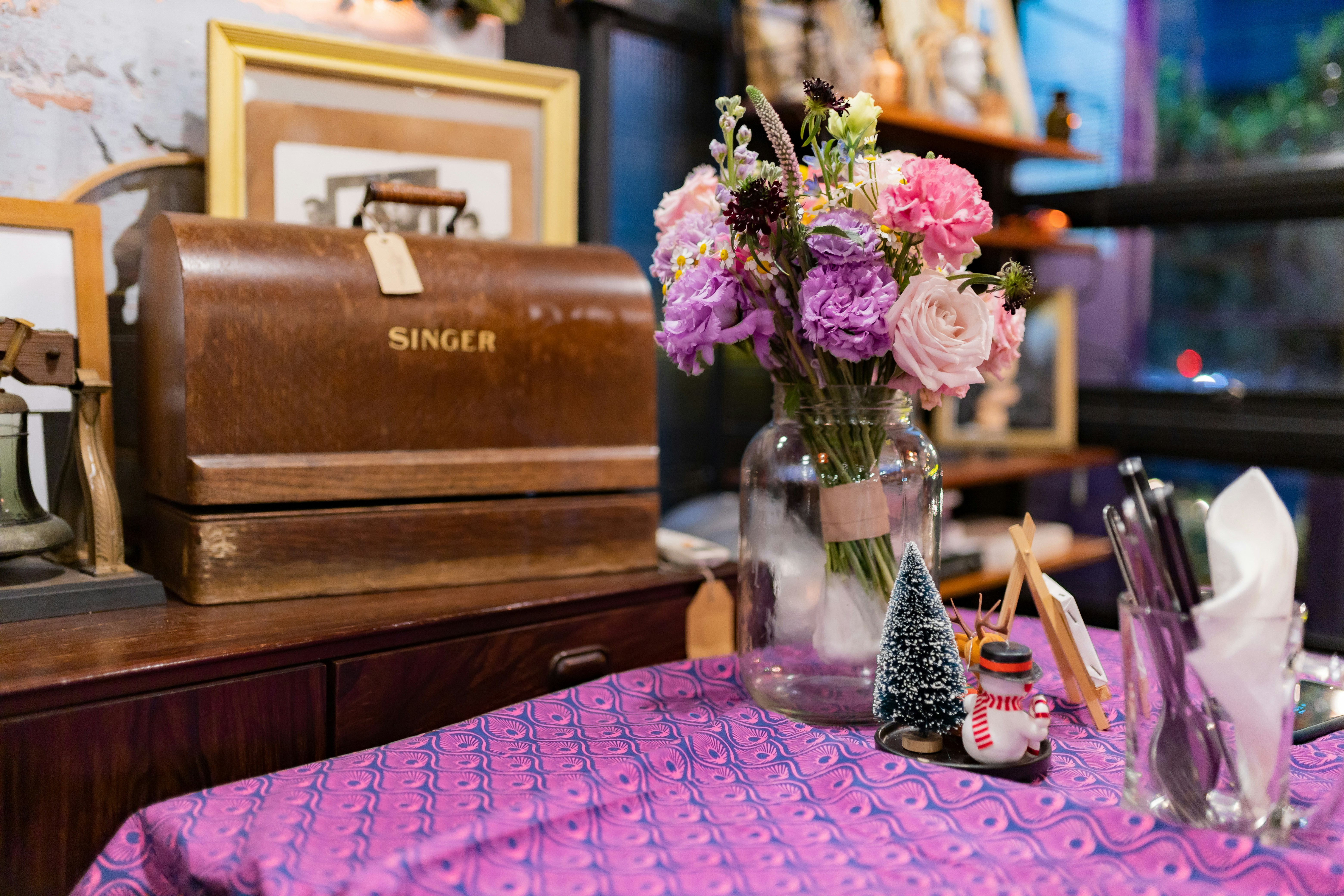 pink and white flowers in clear glass vase on brown wooden table