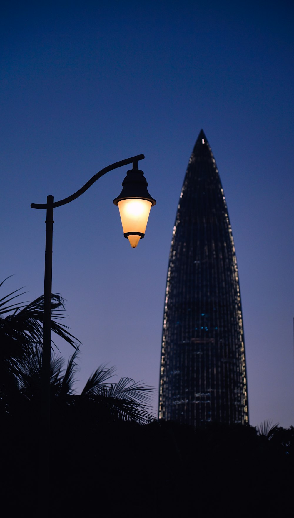 black street light near black metal tower during night time