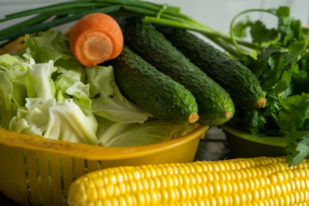 corn and green vegetable on yellow plastic container