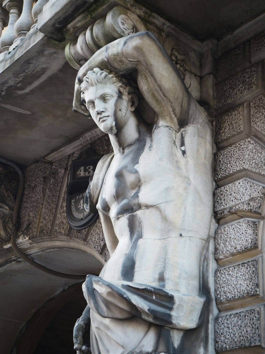 woman statue on brown wooden staircase