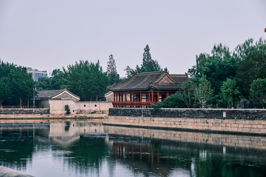 brown and white house near body of water during daytime