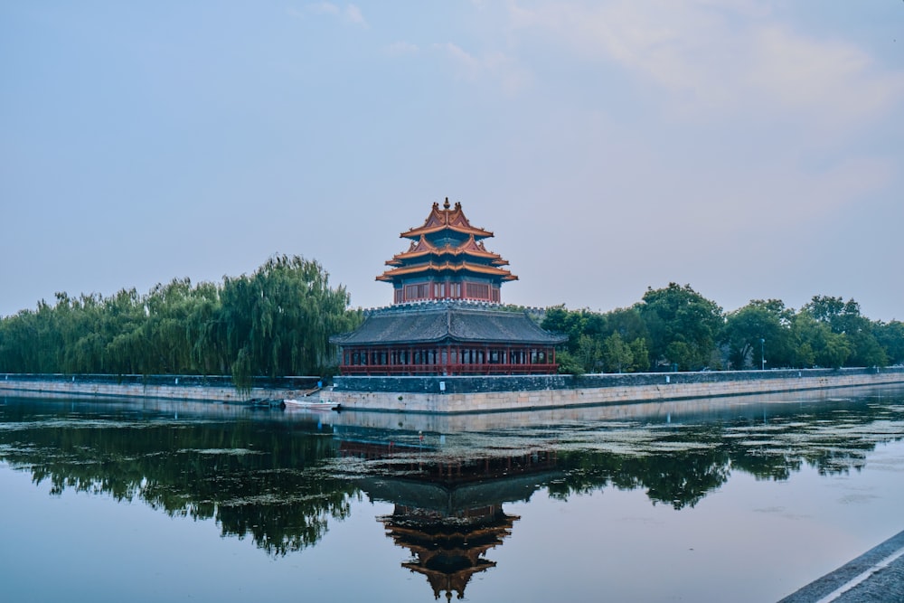 green and brown temple near body of water during daytime