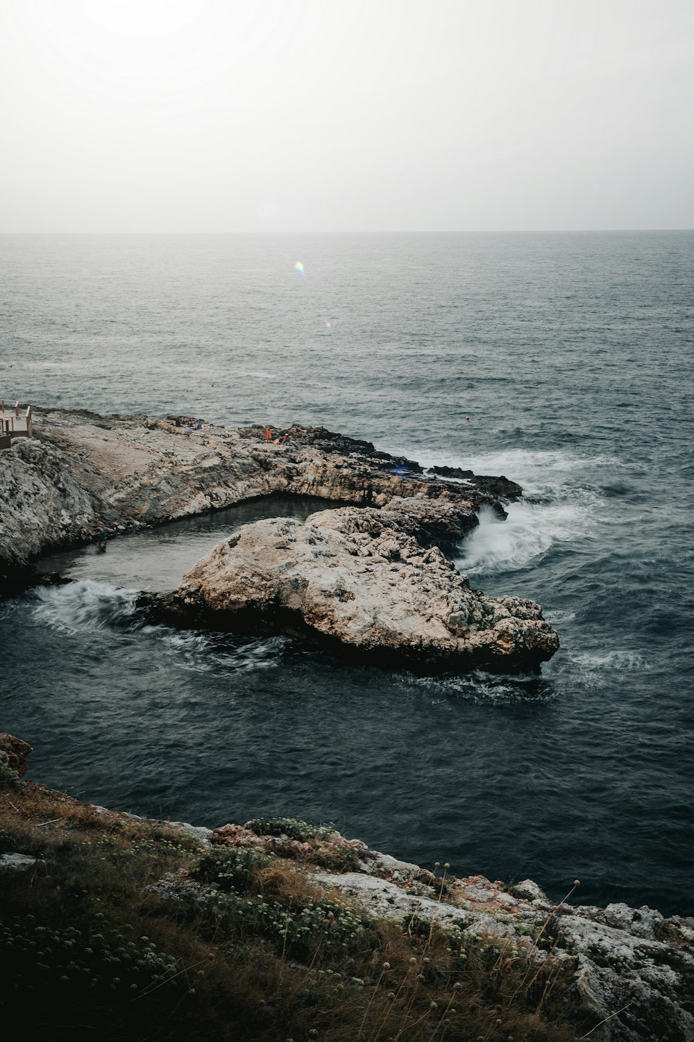 brown rock formation on sea during daytime