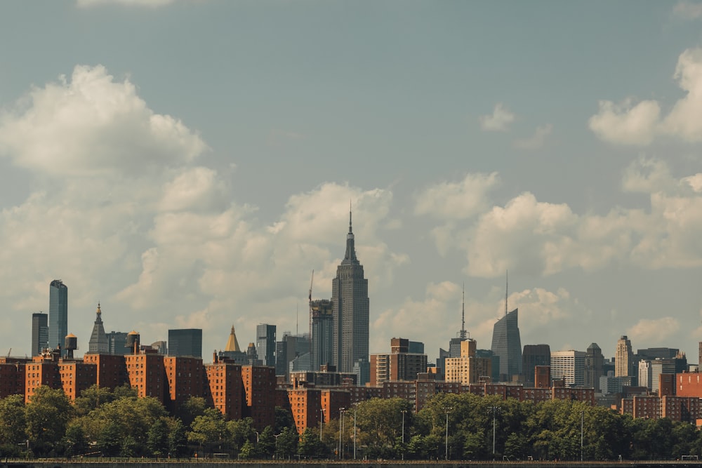 city skyline under white clouds during daytime