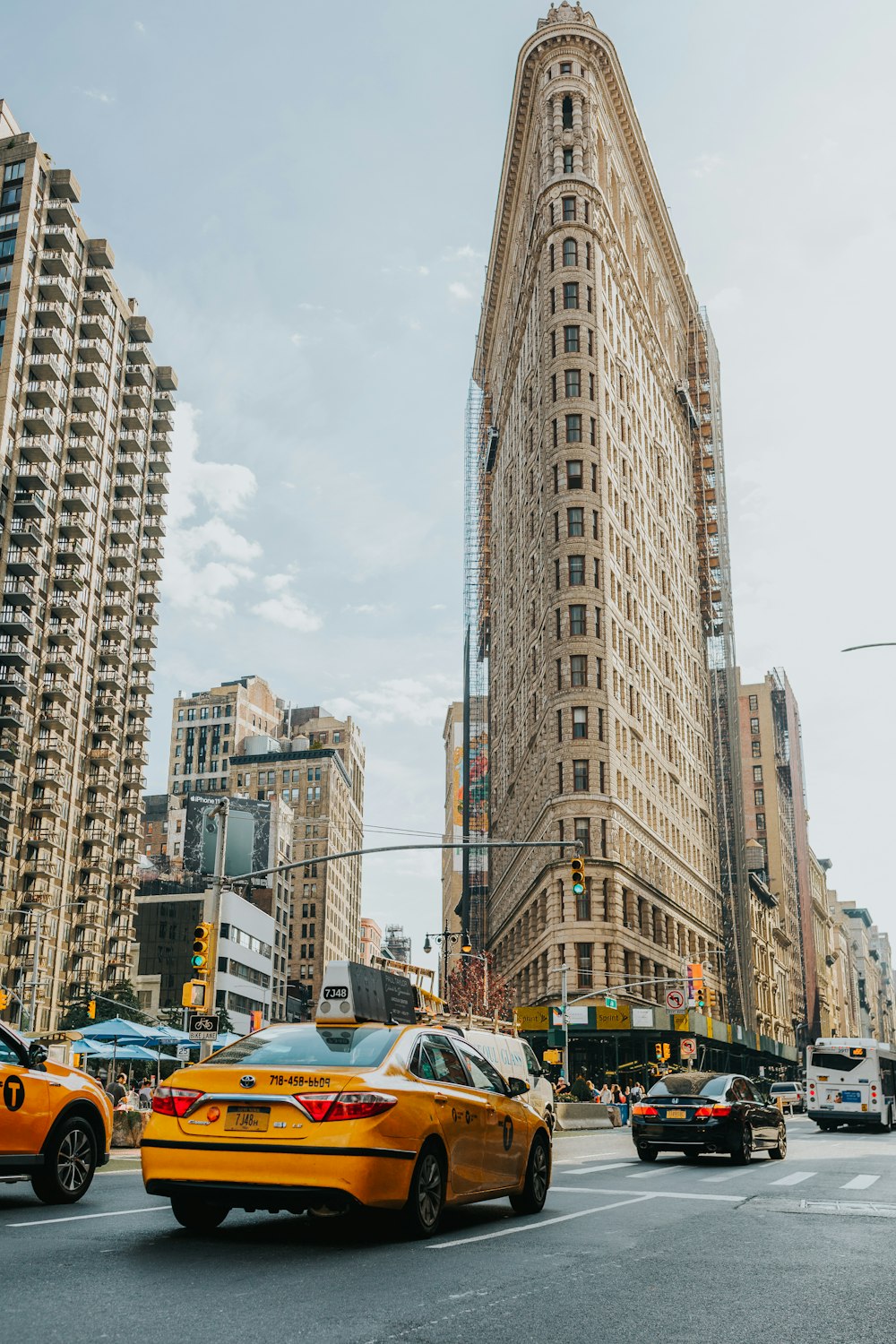 cars on road near high rise buildings during daytime