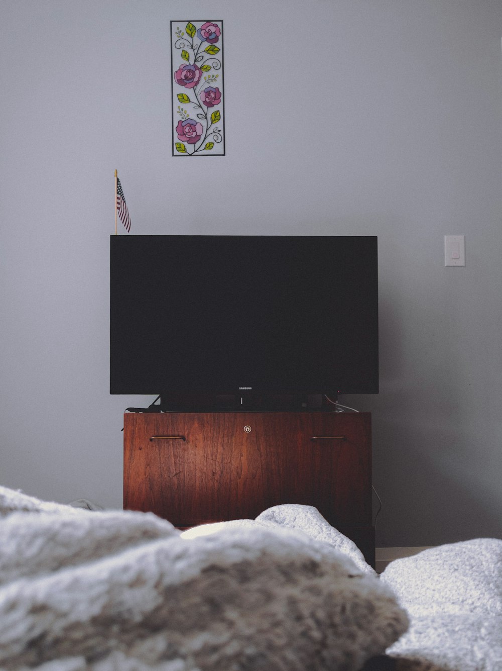 black flat screen tv on brown wooden drawer