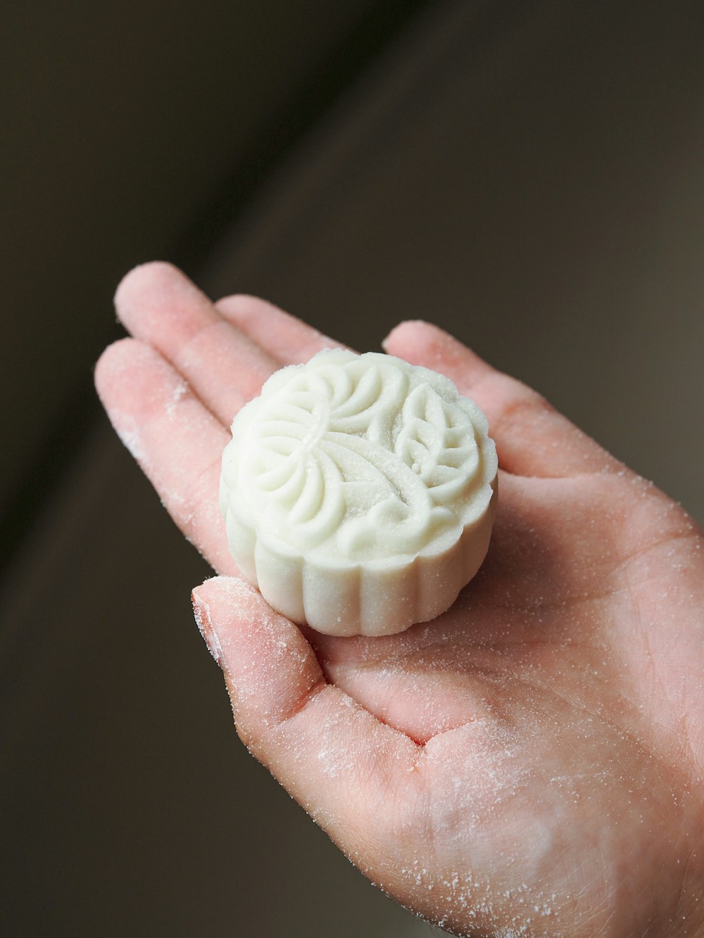 person holding white round ornament