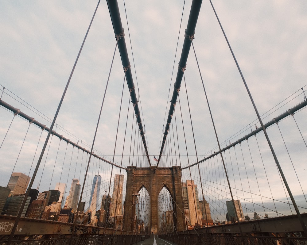 brown and black bridge under white clouds during daytime