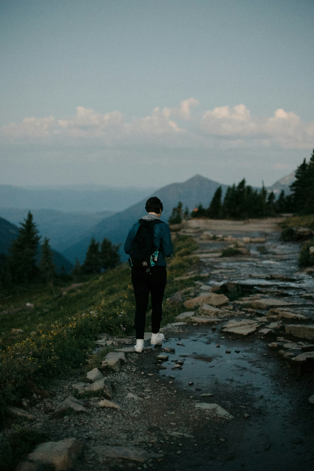 man in black jacket standing on rocky ground during daytime