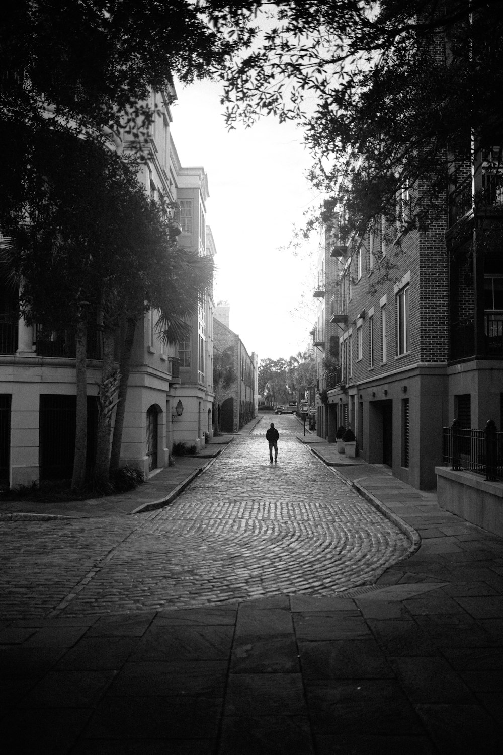 grayscale photo of person walking on street