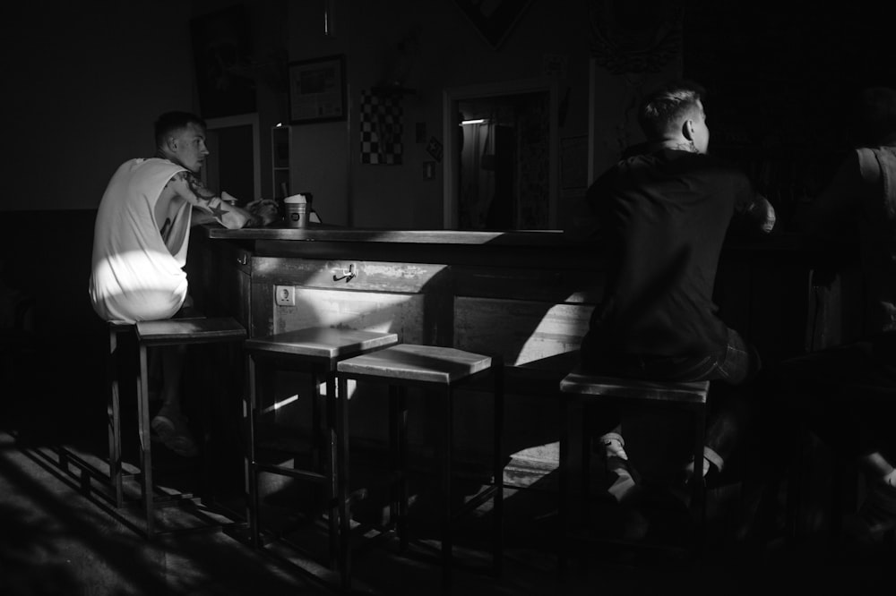 man in black jacket sitting on chair