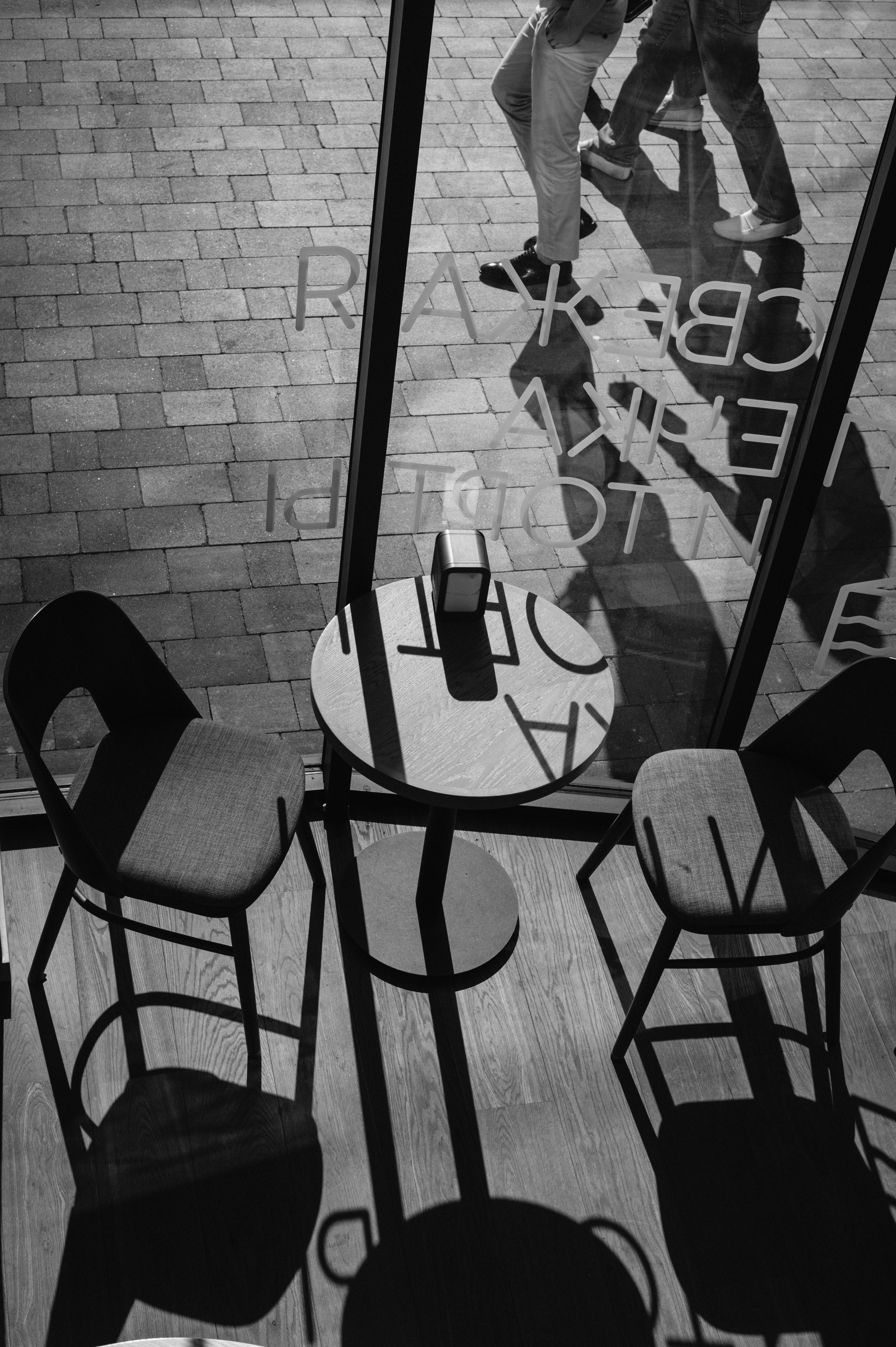 grayscale photo of chairs and table