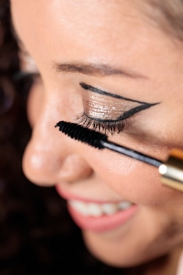 a woman with a brush on her eye