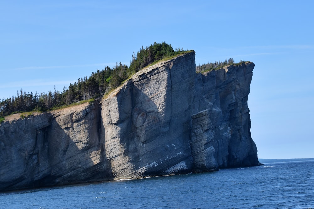 gray rock formation near body of water during daytime