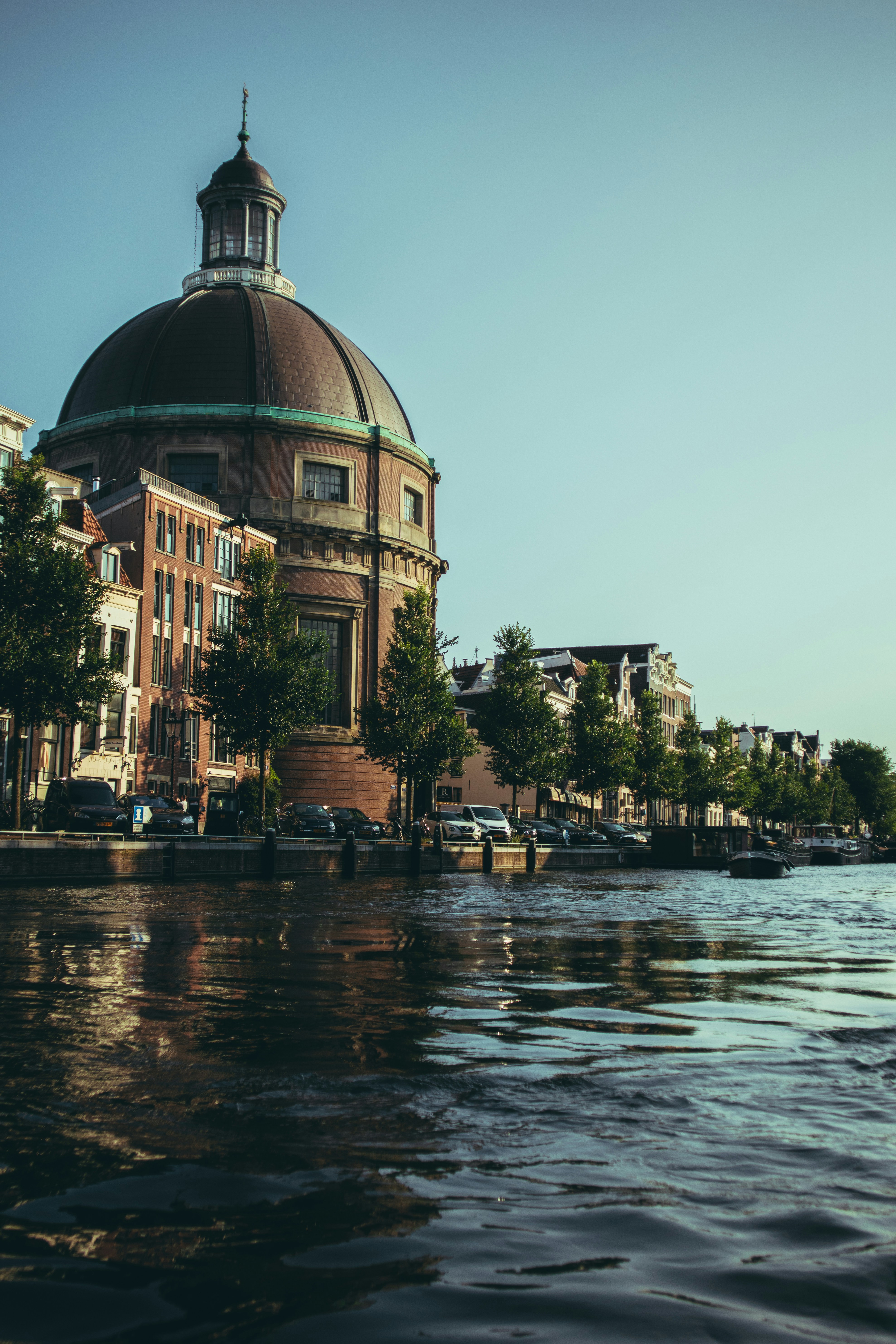 pessoas sentadas no banco perto do corpo de água durante o dia