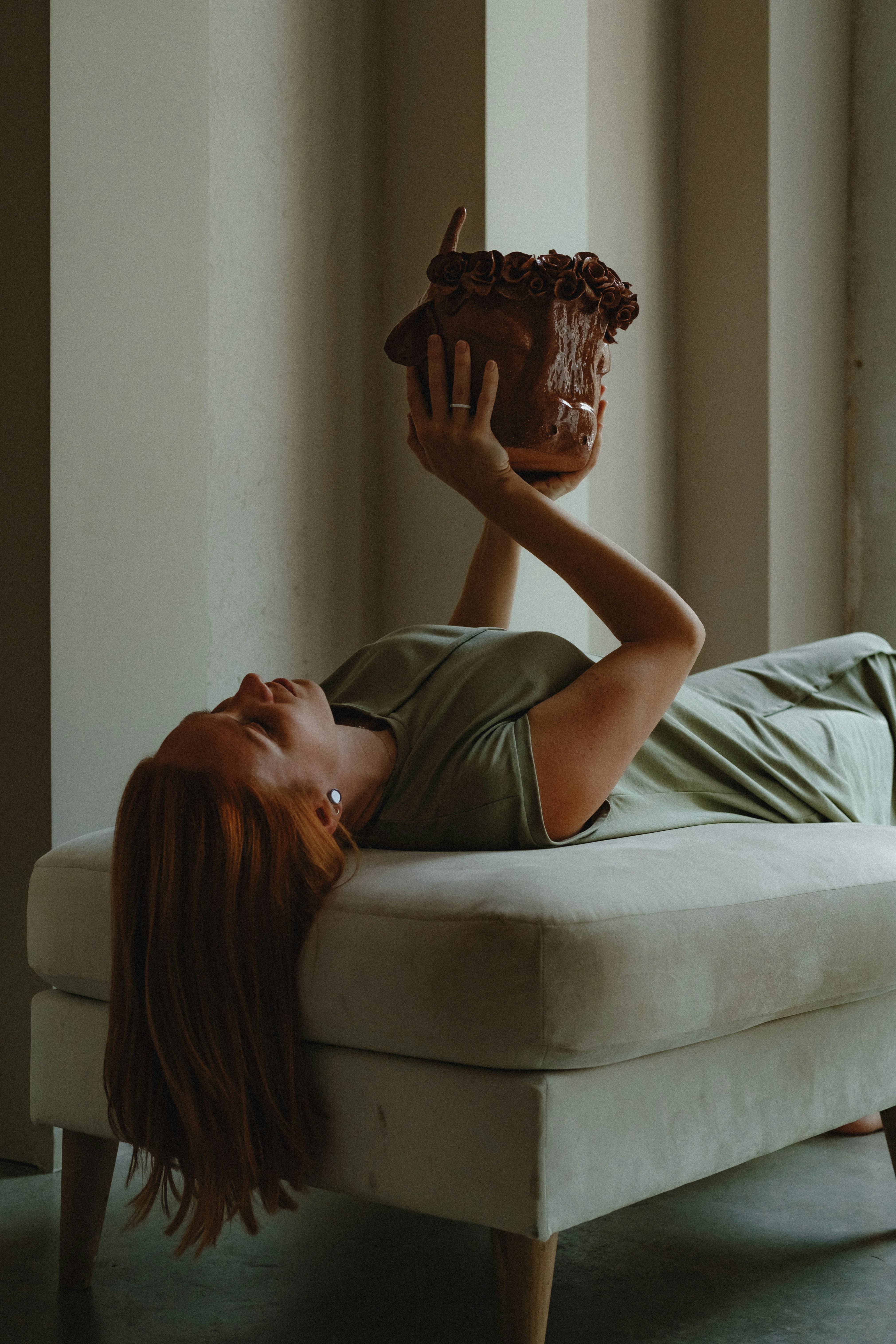 woman in gray shirt lying on bed