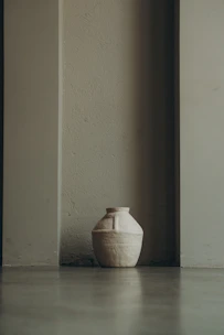 Close-up of a handcrafted ceramic vase with soft natural lighting highlighting its texture