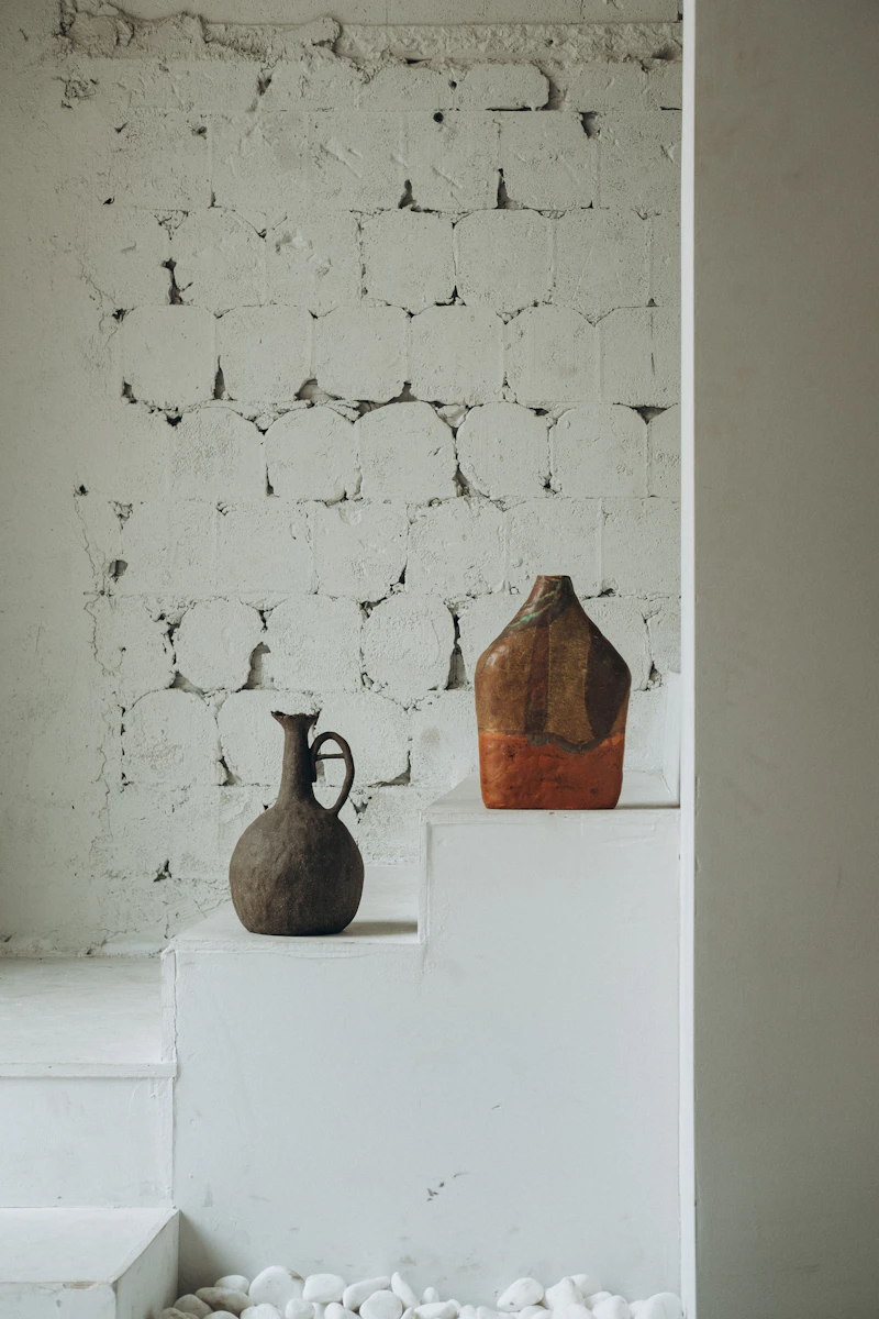 A minimalist pendant light with a warm bulb hanging against a neutral wall