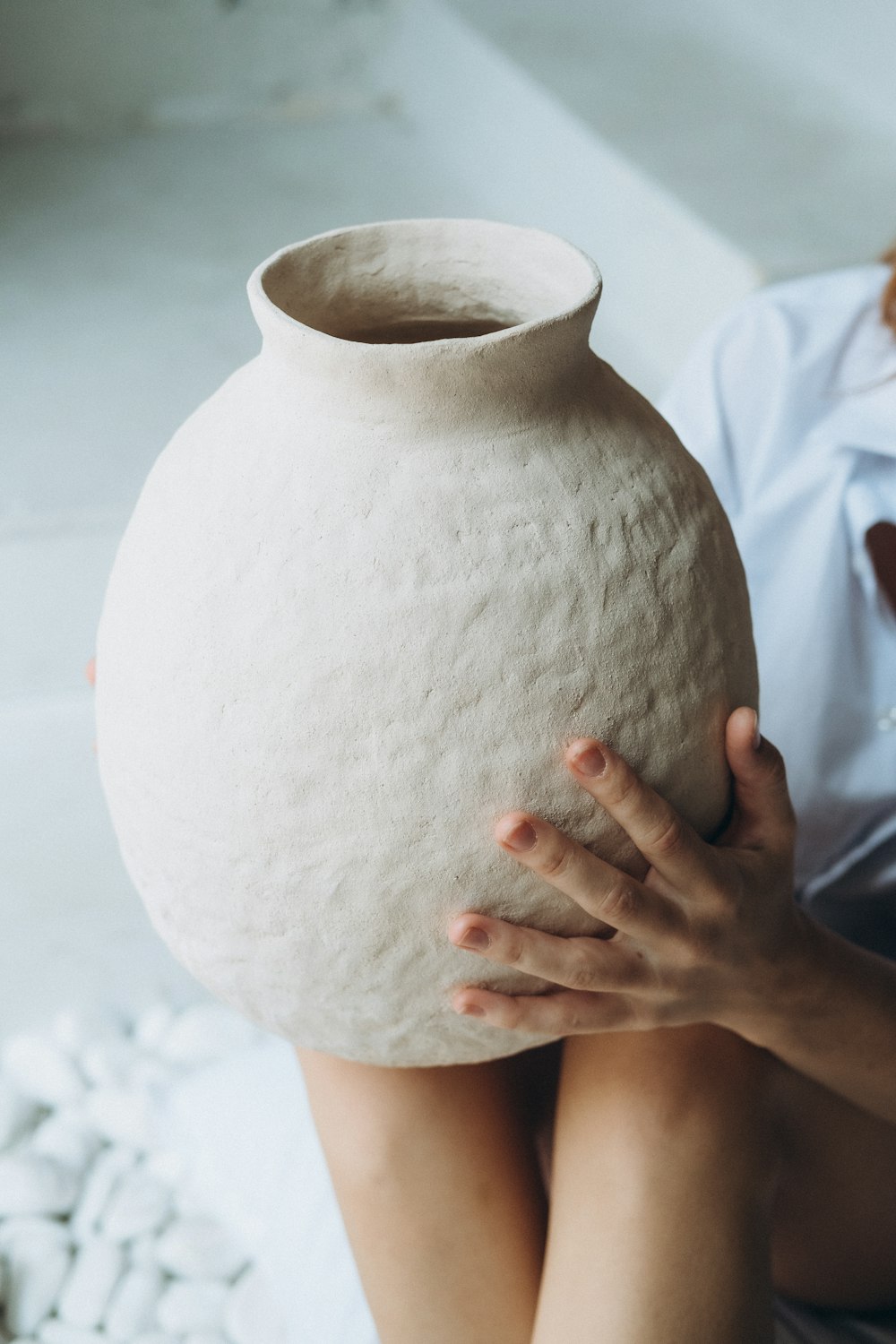 person holding white round ball