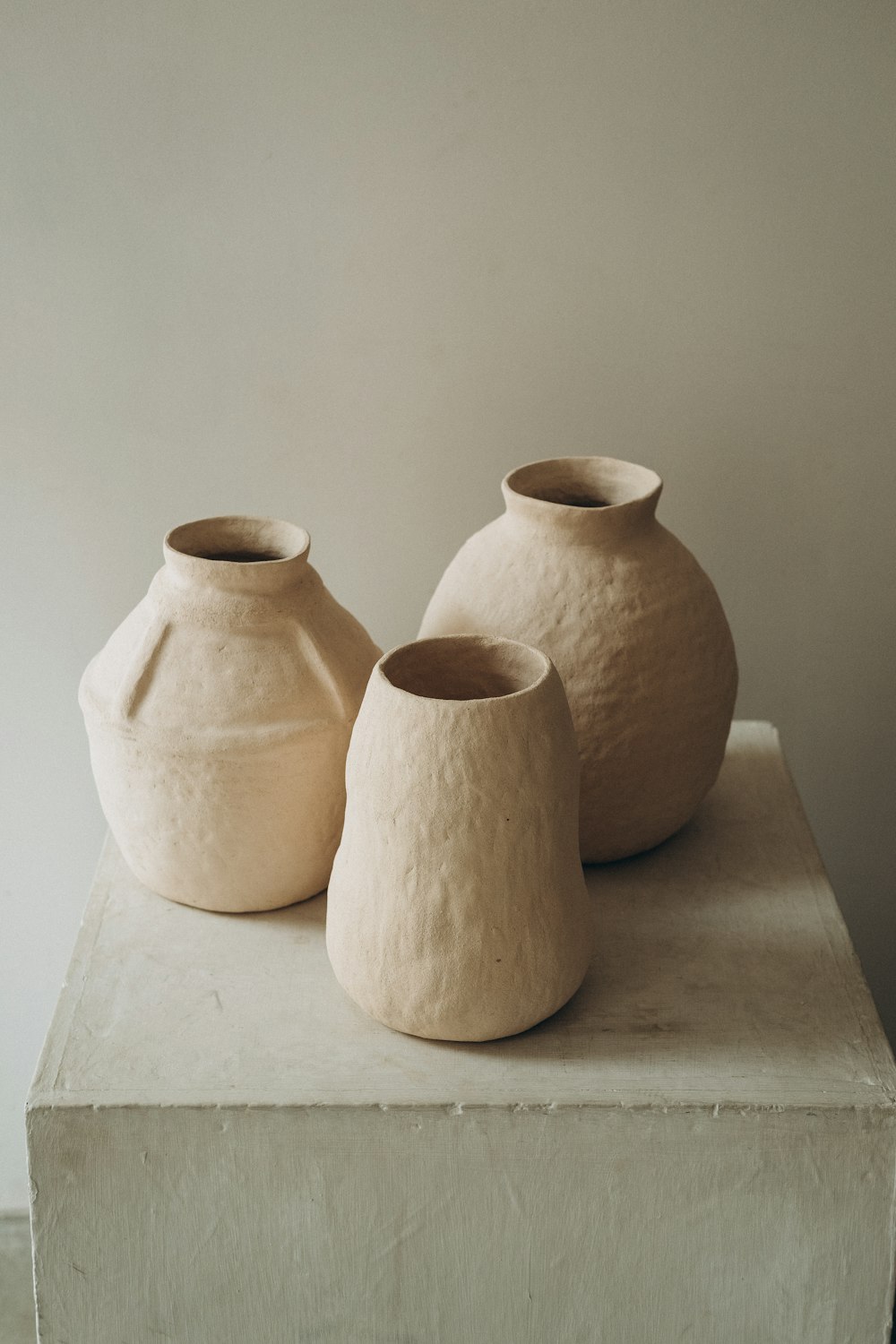 brown clay jars on white table