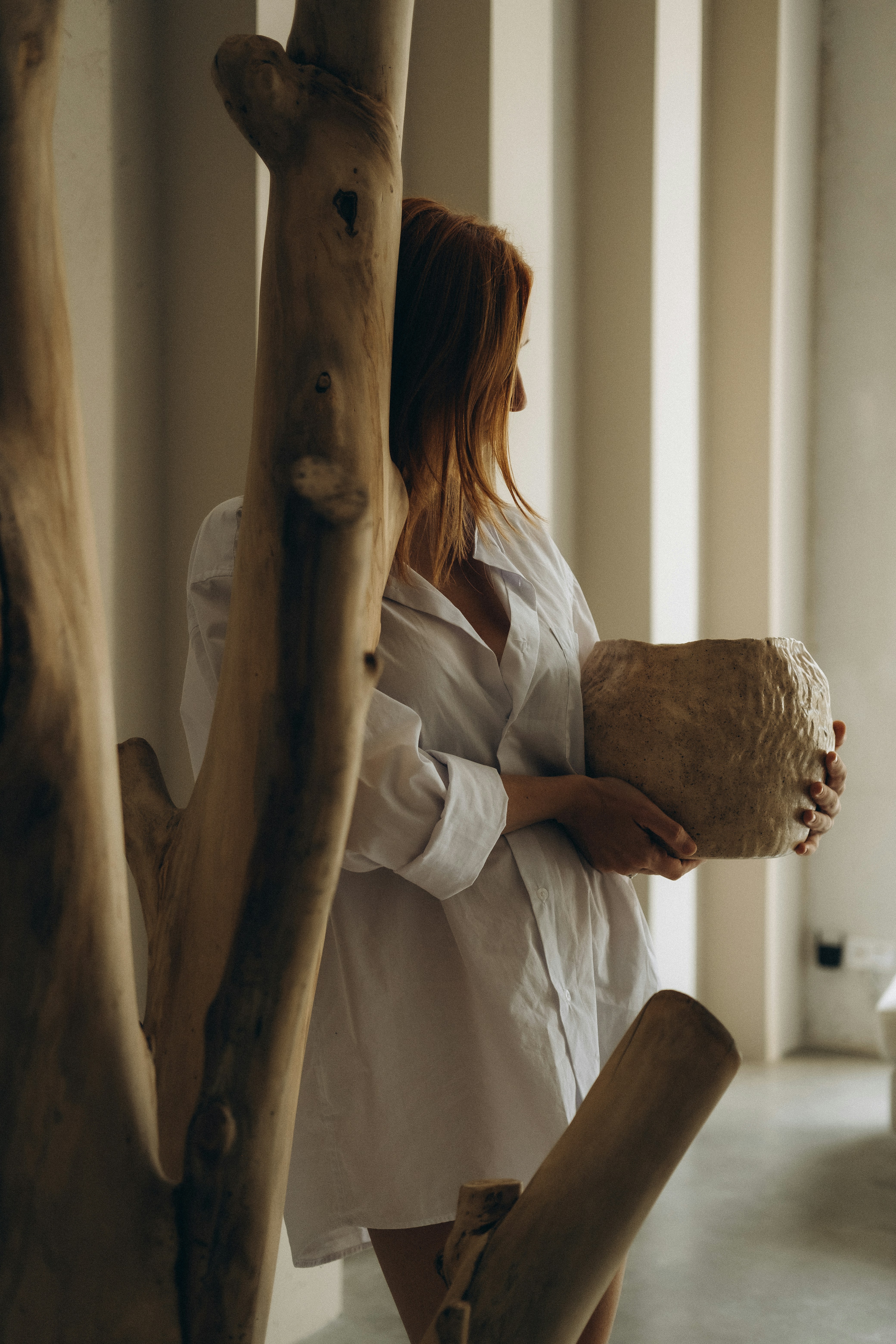 woman in white dress shirt sitting on brown wooden chair