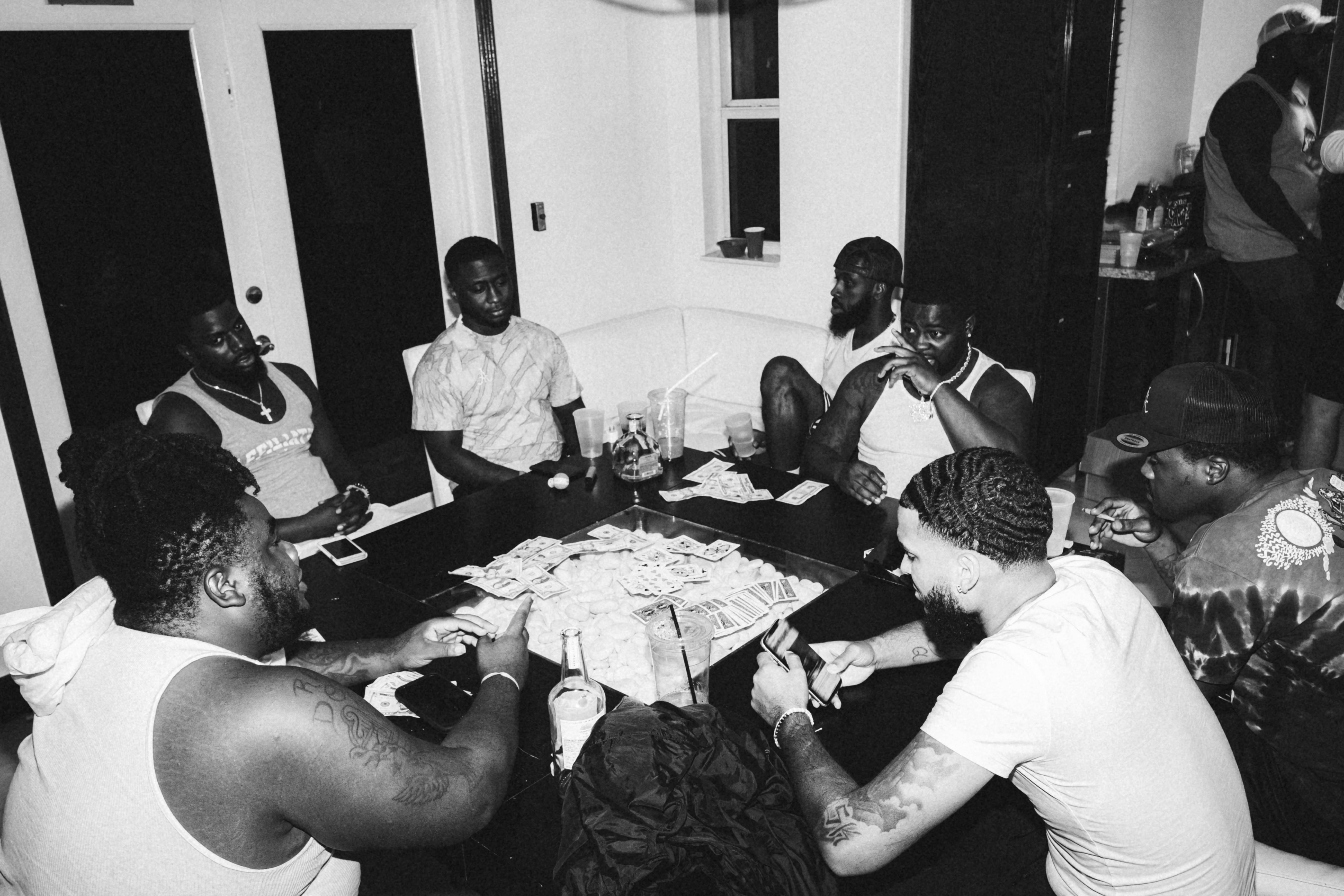 group of men sitting on chair in front of table