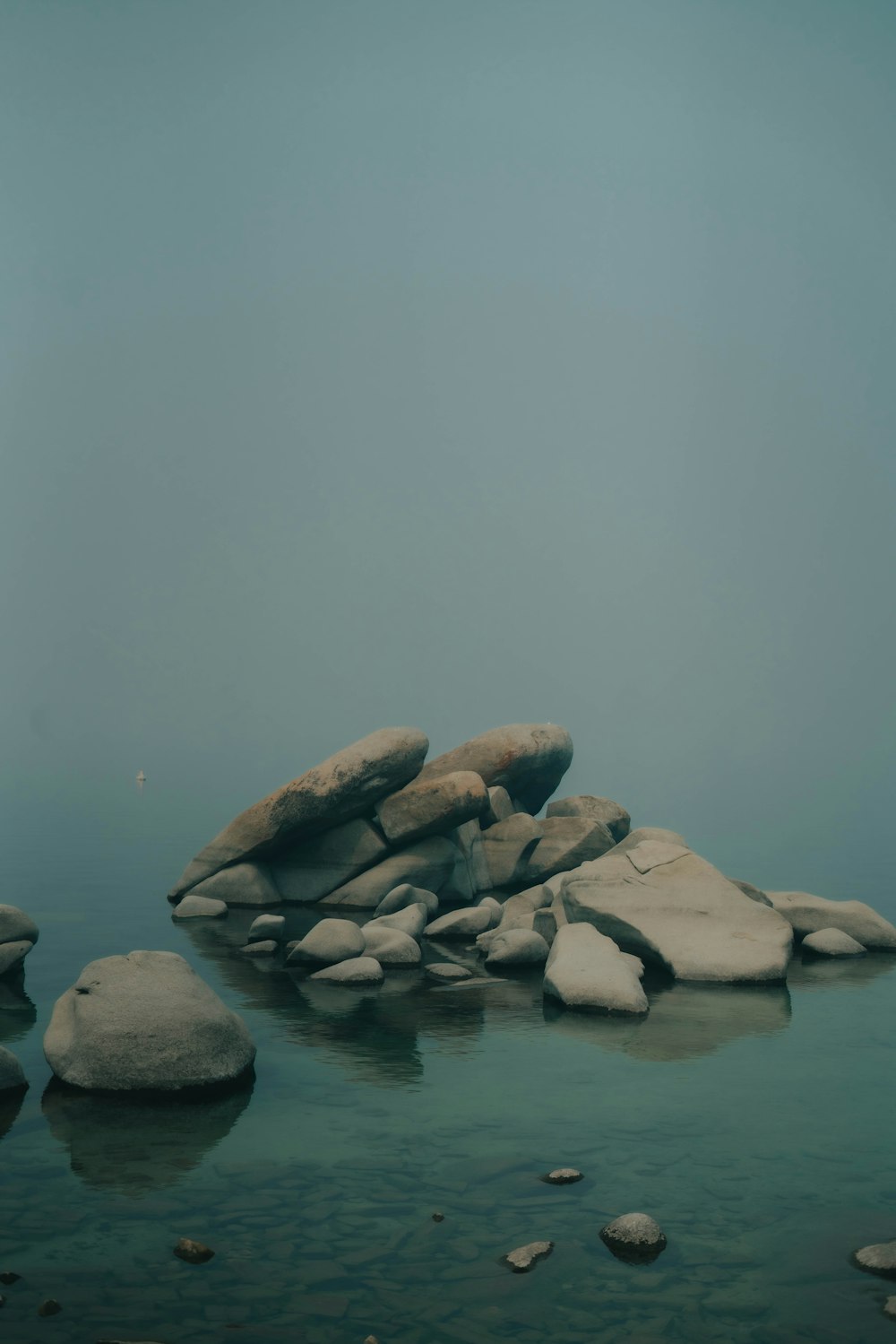 brown rocks on body of water