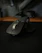 A happy customer holding a sleek wireless mouse from veca electric & technologies in a cozy home office.