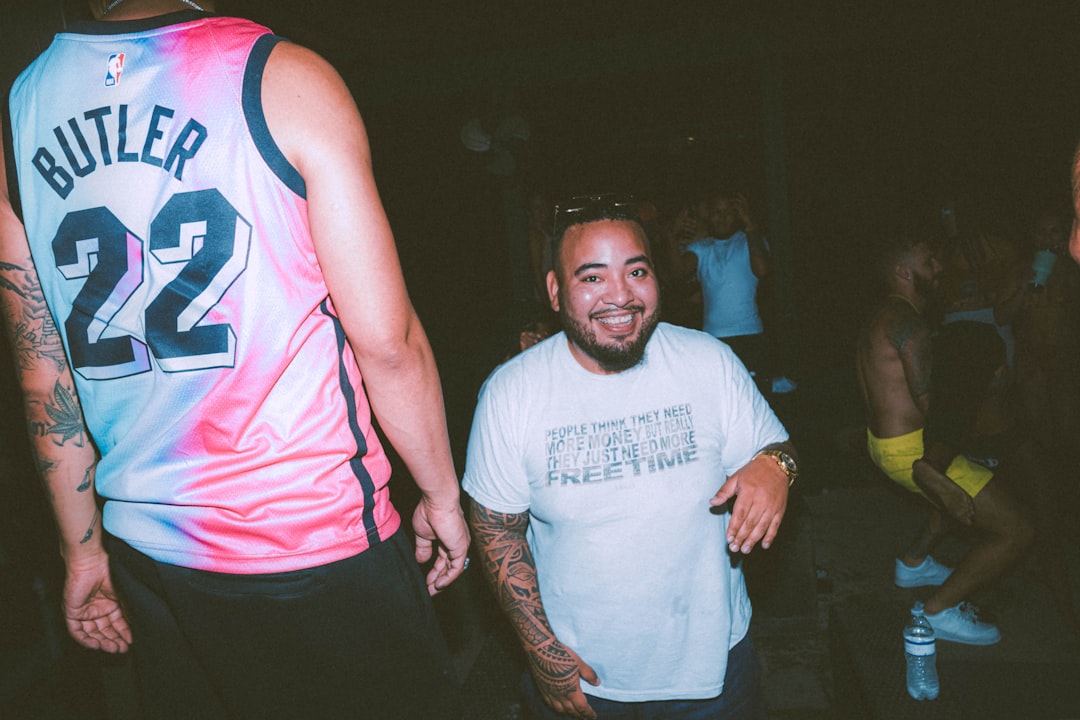 man in white tank top beside man in white tank top