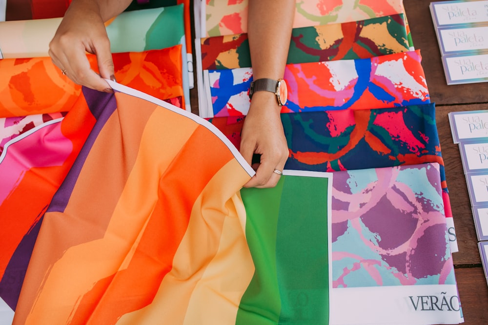 person holding green and yellow tote bag