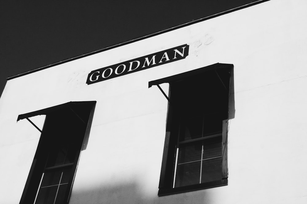 a black and white photo of a building with two windows