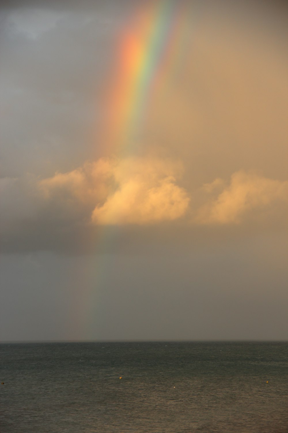 sea under white clouds during daytime