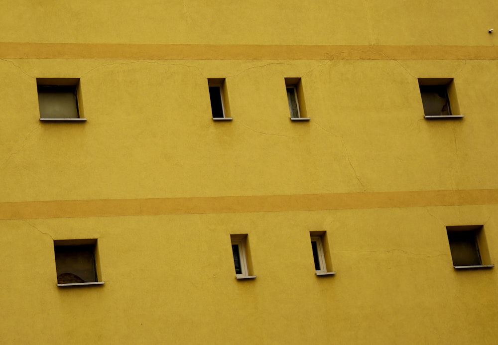 Bâtiment en béton jaune avec fenêtres