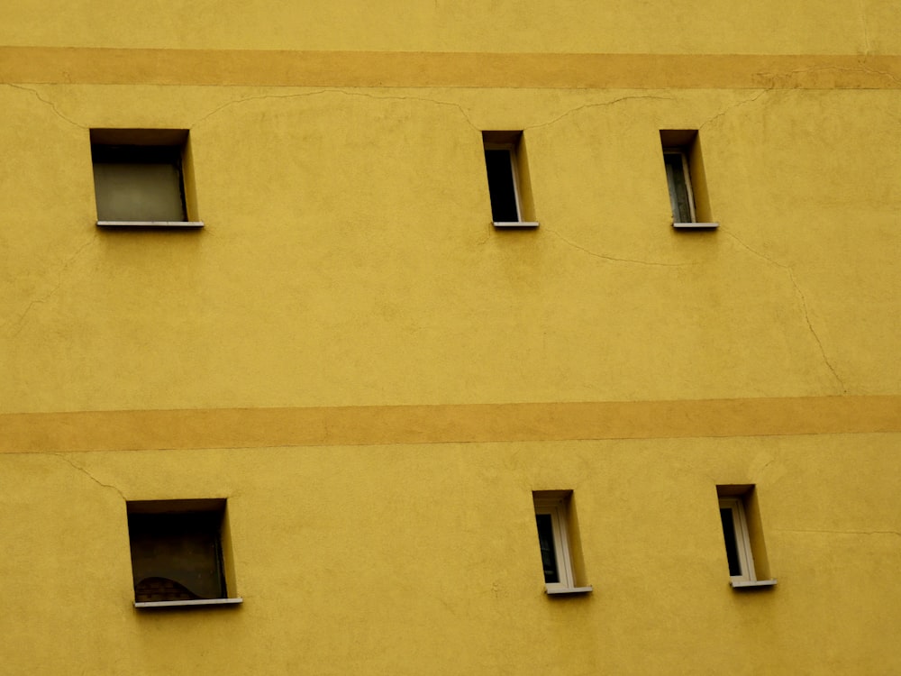 yellow concrete building with windows