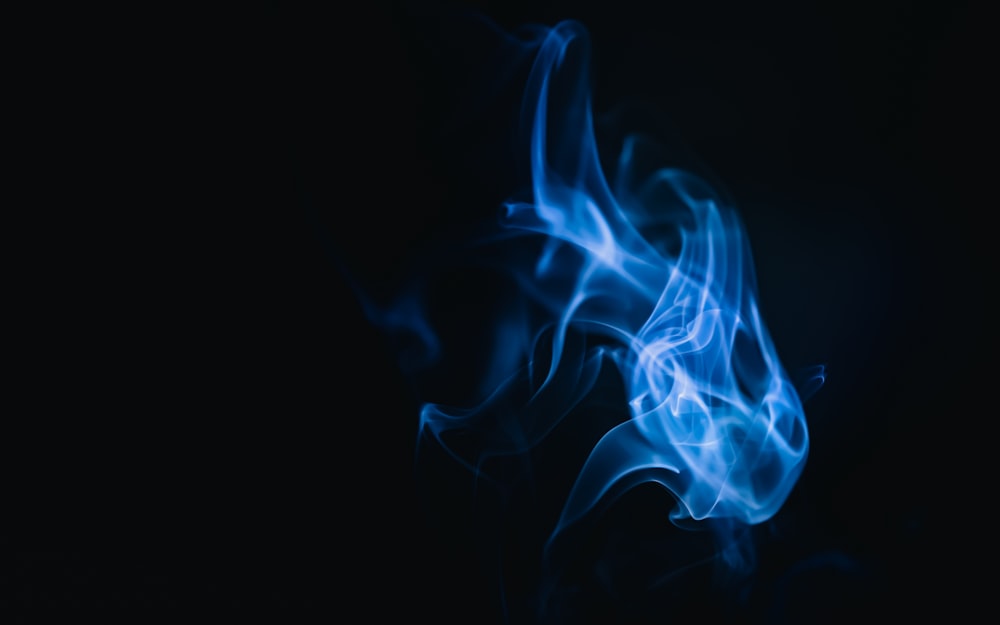 a close up of blue smoke on a black background