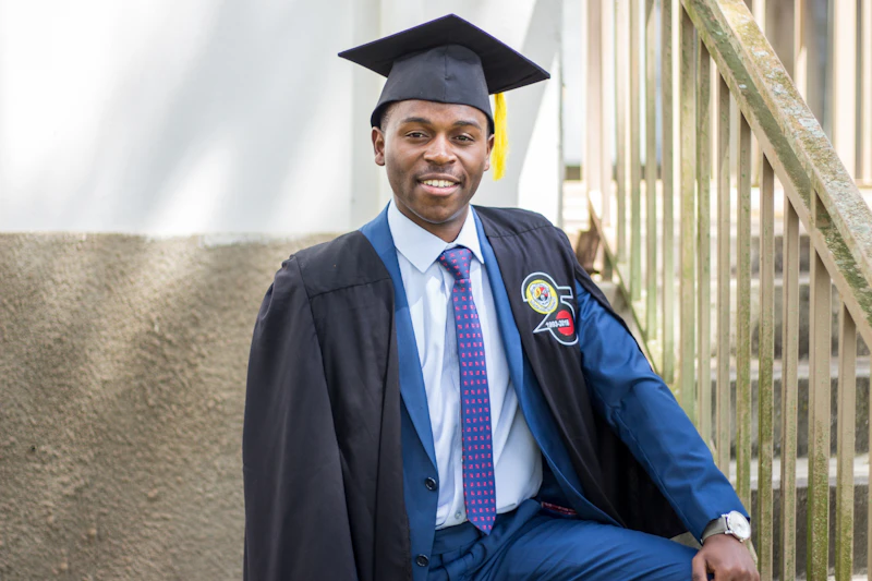 David wearing a graduation cap and gown