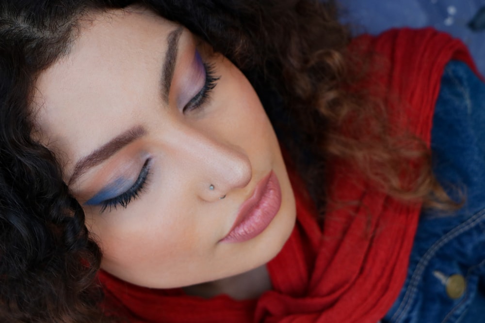 woman in red scarf taking selfie