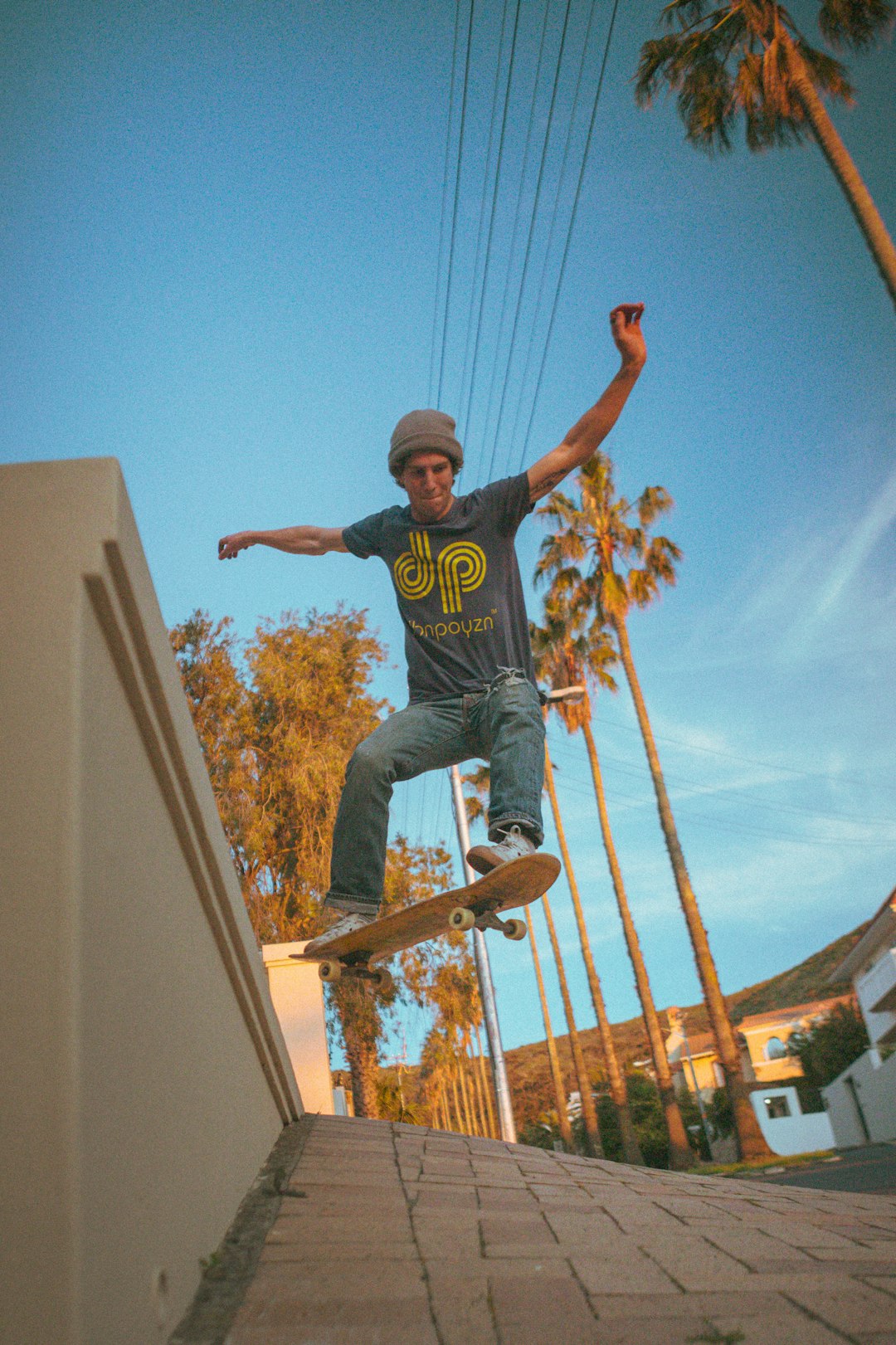 man in black crew neck t-shirt jumping on brown wooden ladder during daytime