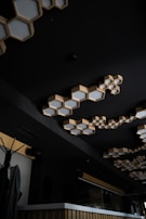 Electrician mounting lighting fixtures in a modern home interior