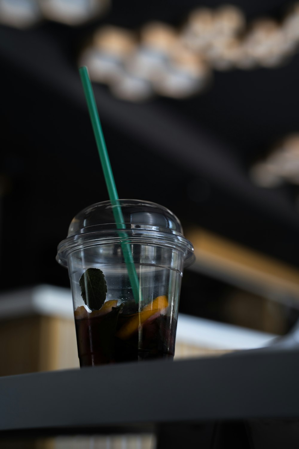 clear plastic cup with black liquid