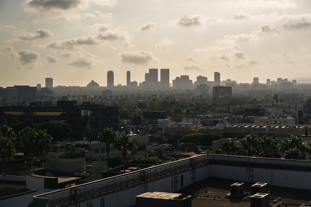 city buildings under white clouds during daytime