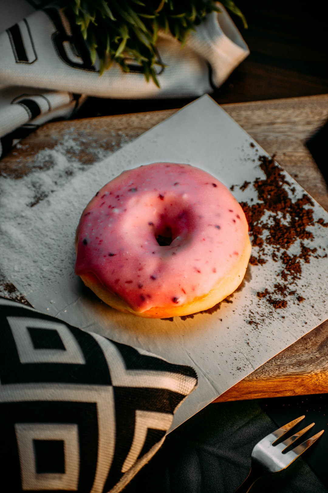 pink doughnut on white and black textile