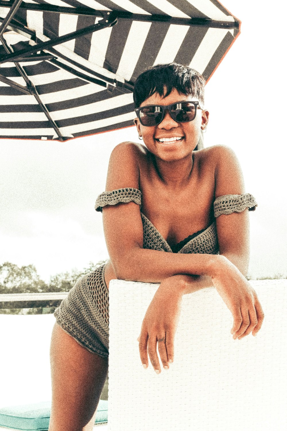 woman in black and white stripe bikini top wearing black sunglasses