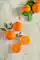 Sliced fresh mandarins arranged on a light surface