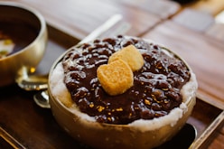 brown and white chocolate cake on white ceramic plate