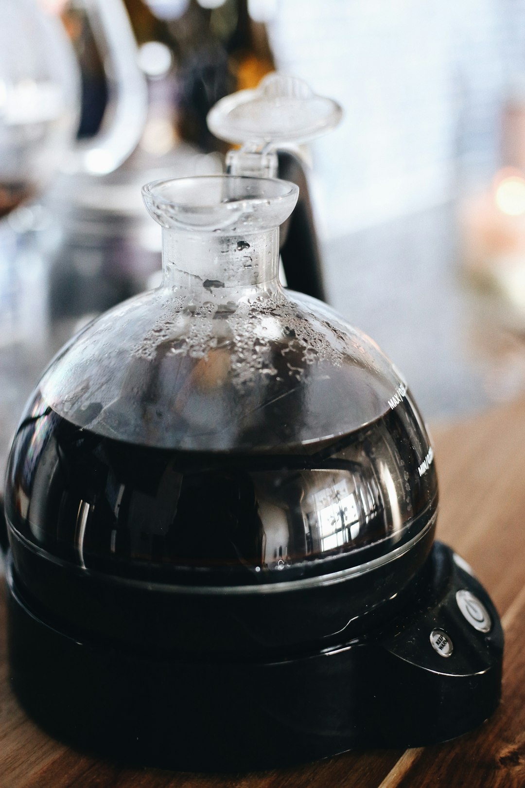 clear glass bottle with black liquid